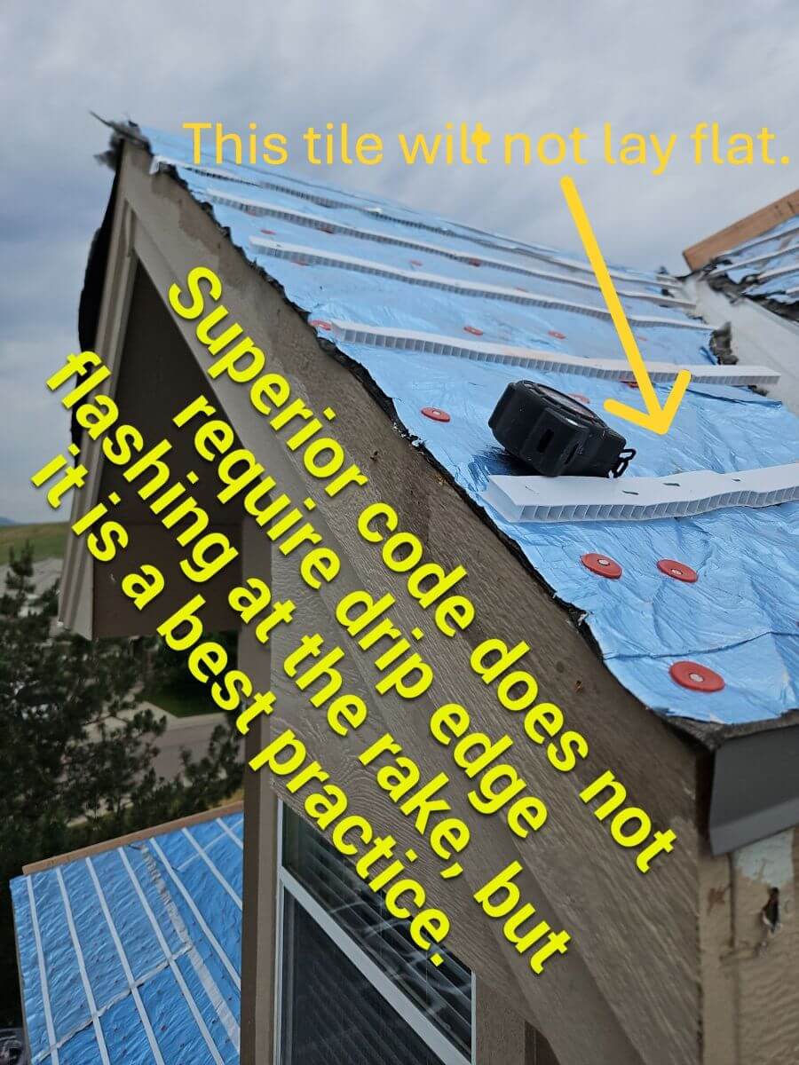 A rake edge of a tile roof without drip edge flashing, causing the tile to not lay flat.