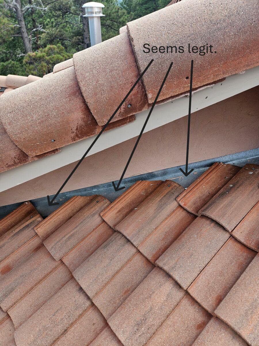 Improperly installed flashing on a concrete tile roof.