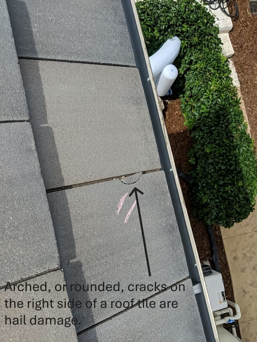 A perfect example of a cracked chip from hail on a concrete roof tile.