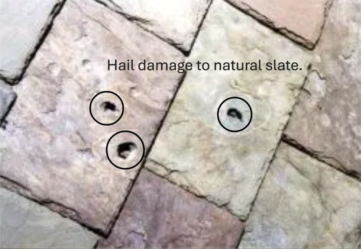 Multiple hail damage puncture marks on a natural slate roof.